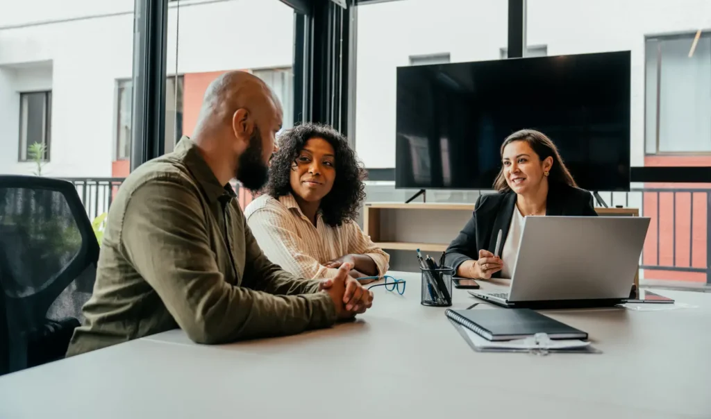 Couple and woman in office discussing new hampshire trust advantages