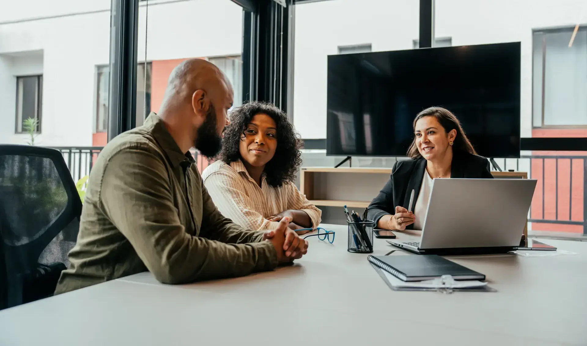 Couple and woman in office discussing new hampshire trust advantages