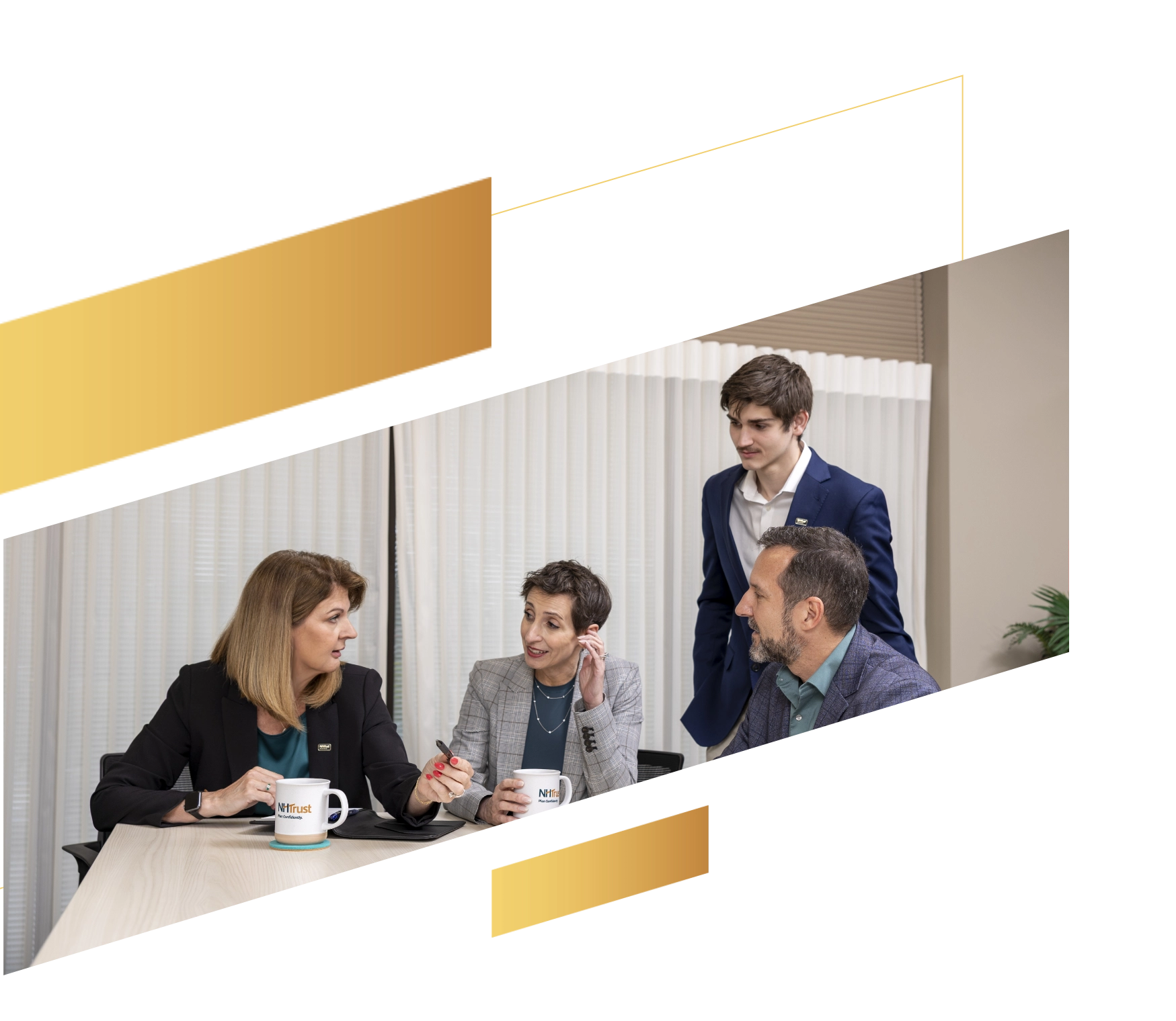 Four professionals in business attire discuss wealth management strategies around a table with coffee mugs in an office setting.