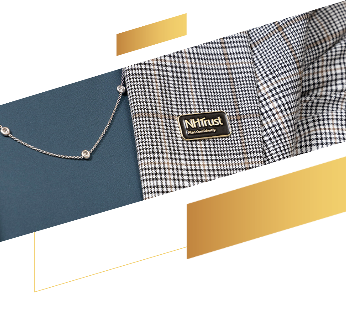 Close-up of a plaid blazer with an NHTrust pin and part of a necklace, on a blue and white background—perfect for discussing your 529 plan in style.