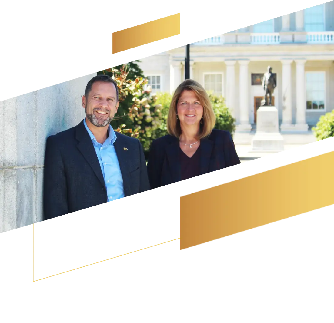 Two people in business attire stand outside in front of a building and statue, with gold graphic accents highlighting their focus on financial planning.