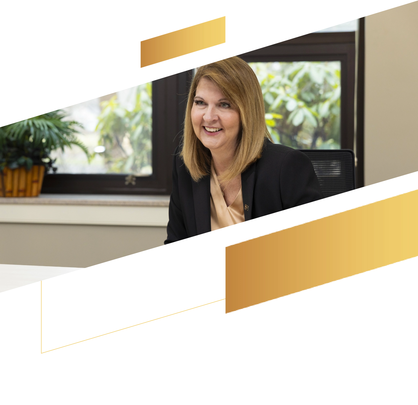 Smiling woman with shoulder-length hair sits at a desk in an office, a plant and window behind her, embodying professionalism in wealth management.