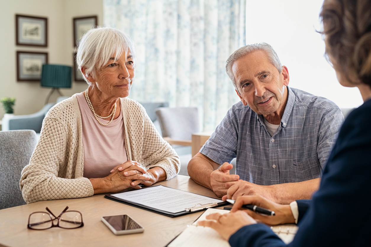 Older couple discussing retirement options with financial advisor